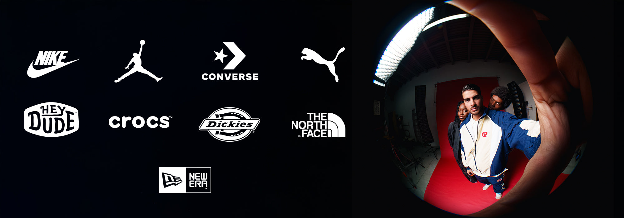 A wide promotional banner showcasing logos from brands Nike, Jordan, Converse, Puma, Hey Dude, Crocs, Dickies, The North Face, and New Era, alongside a fisheye lens photograph of three people dressed in streetwear posing against a vibrant red studio backdrop.